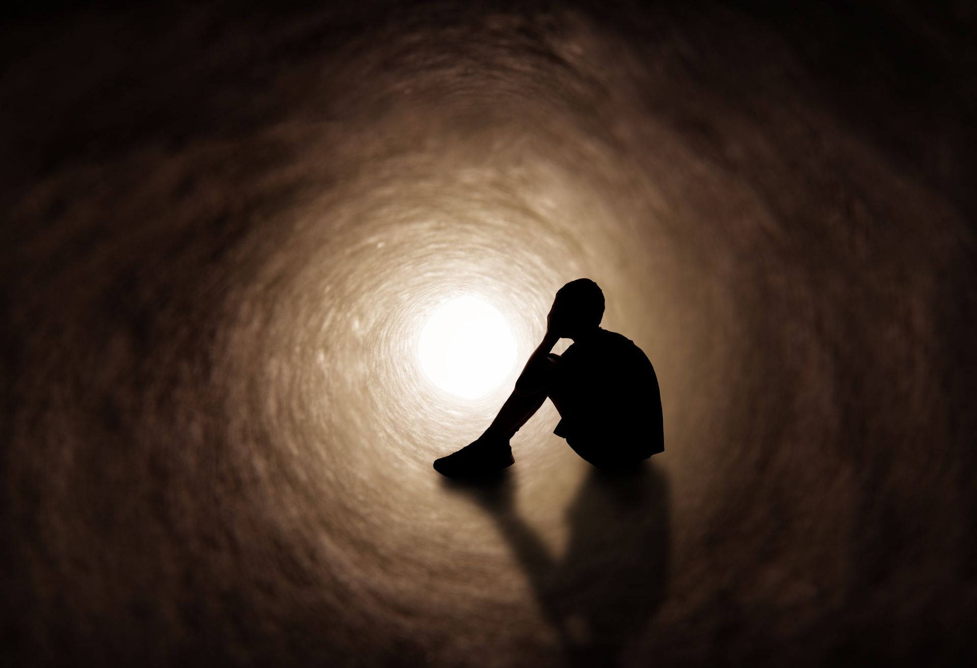 Graphic showing silhouetted person against tunnel of light