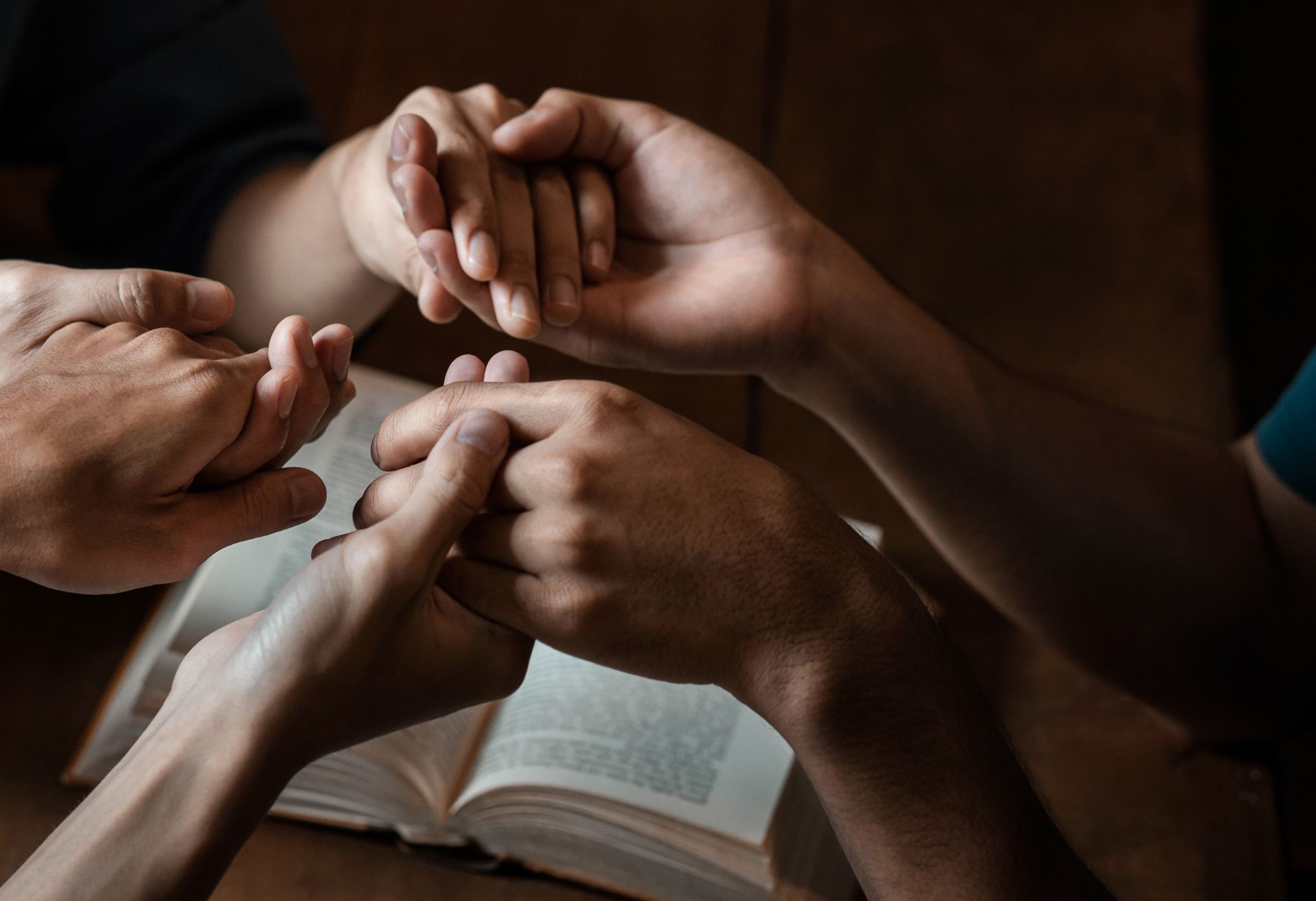 Image of hands over a bible